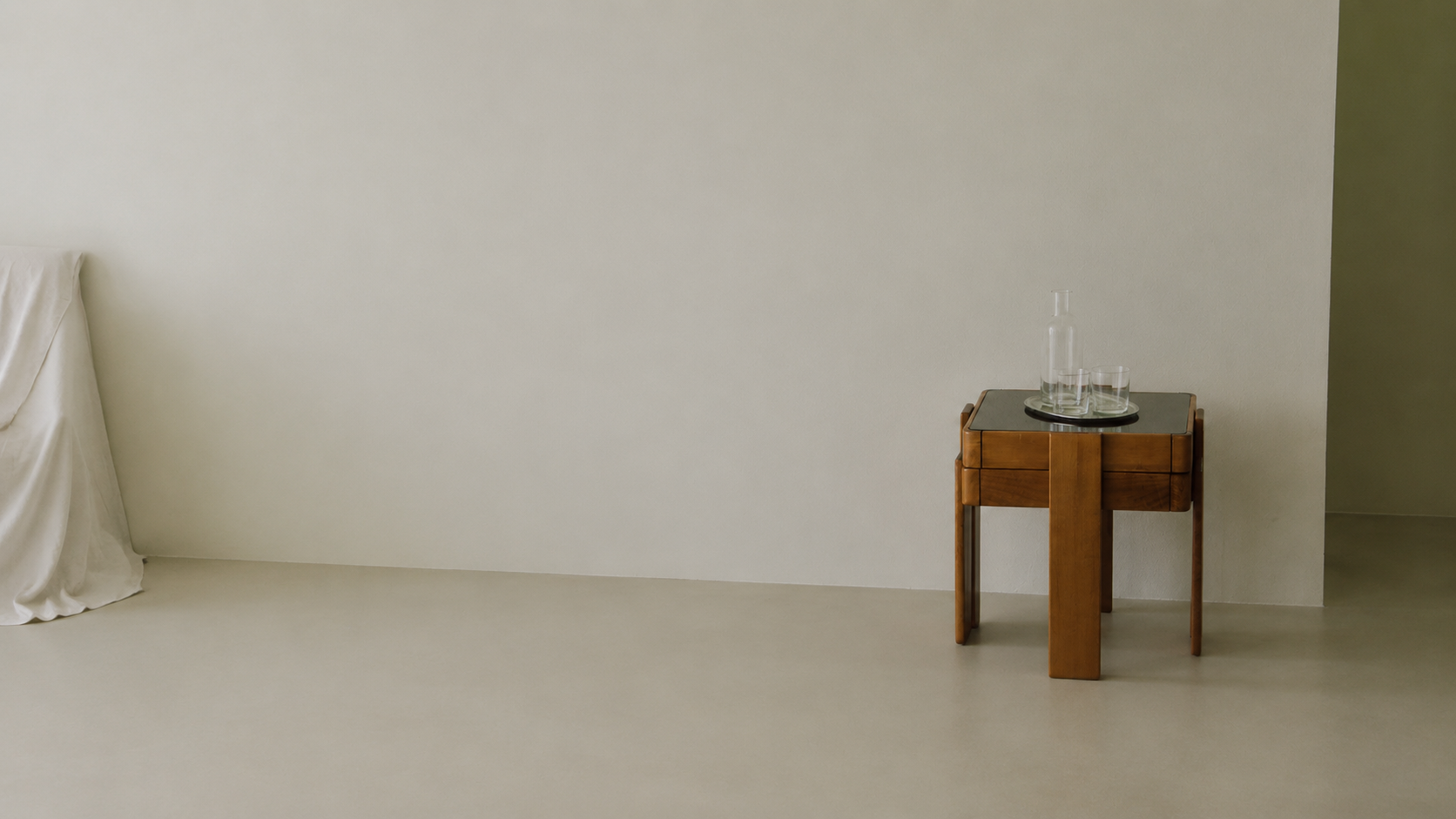 A quiet room with a wooden table and glass carafe